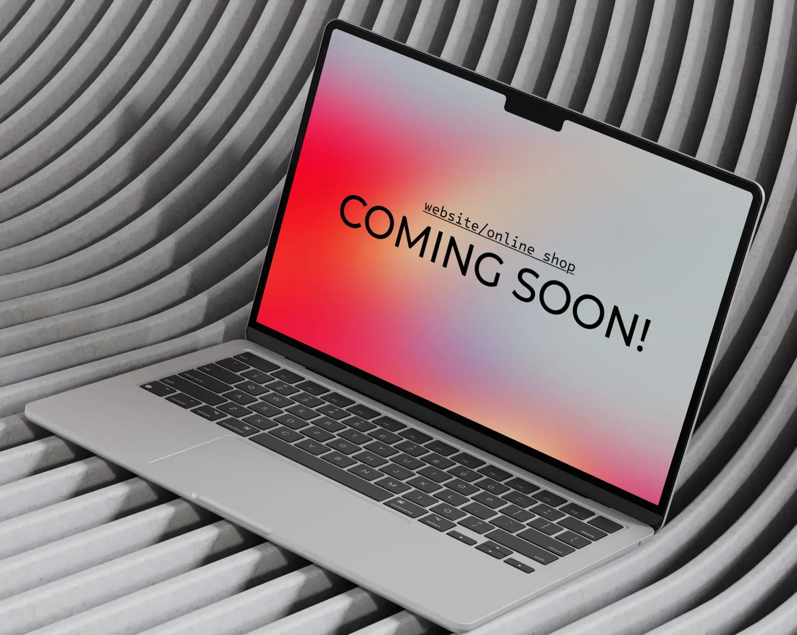 A laptop showing a “website / online shop coming soon” placeholder screen